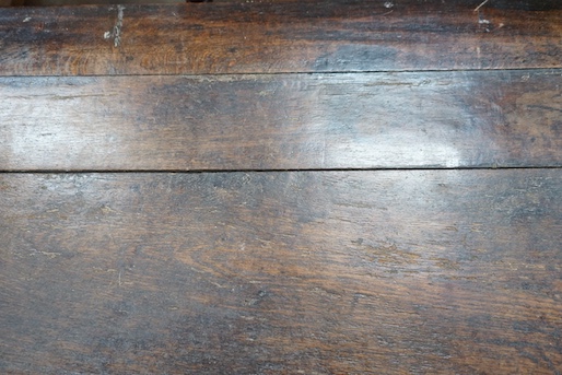 An 18th century and later carved panelled oak coffer, width 145cm, depth 58cm, height 61cm